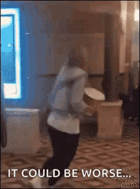 a person is dancing in a room with the words `` it could be worse '' .