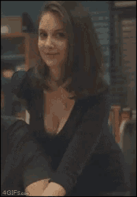 a woman with a plunging neckline is smiling in a 4gifs.com image