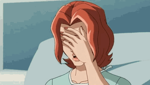 a woman covering her face with her hand in a hospital bed