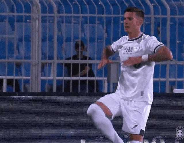 a soccer player wearing a white shirt that says yam on the front