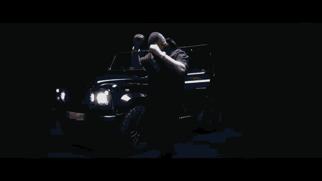 a blurry picture of a man holding a gun in a dark room