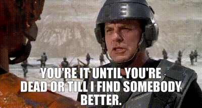 a man wearing a helmet and headphones is talking to another man .