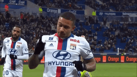 a soccer player wearing a hyundai jersey is celebrating