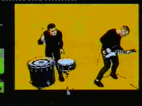 a man playing drums and a man playing a guitar