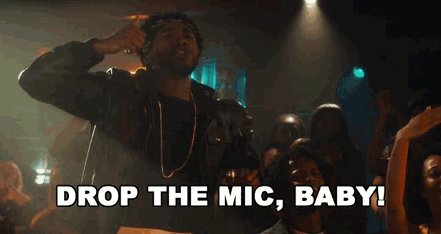 a man singing into a microphone with the words drop the mic baby