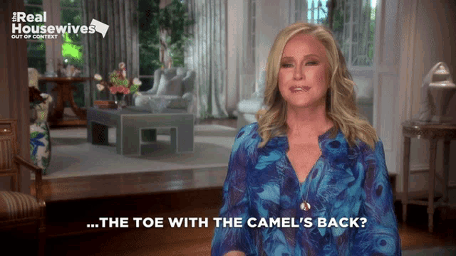 a woman says the toe with the camel 's back in a living room