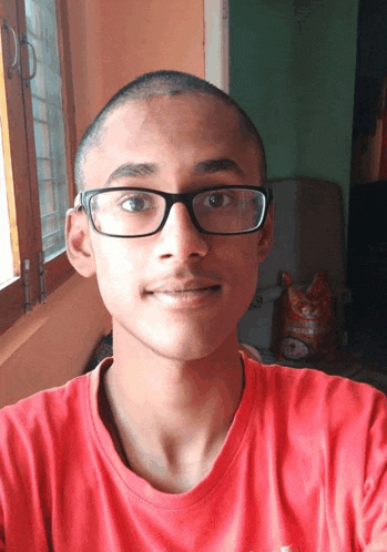 a young man wearing glasses and a red shirt