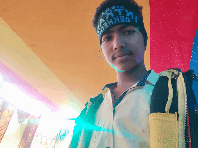 a young man wearing a headband that says " dekhed " on it