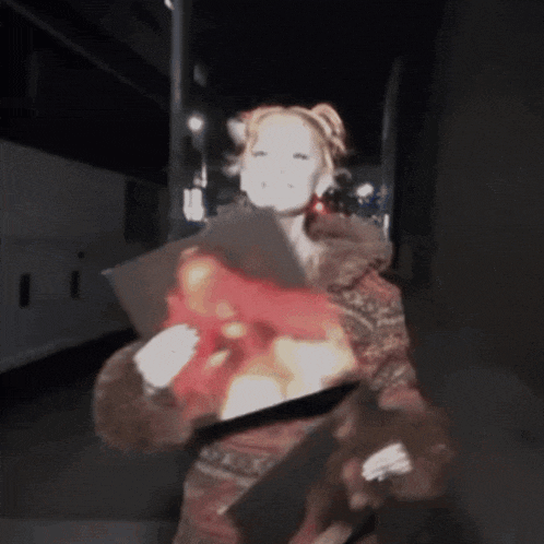 a woman in a fur coat is holding a bouquet of flowers in her hands