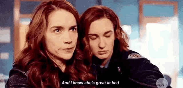 two women are hugging each other and one of them is saying `` and i know she 's great in bed . ''