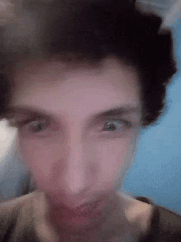a close up of a person 's face with a blurry background