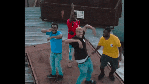 a group of young men are dancing in front of a dumpster that says loading zone