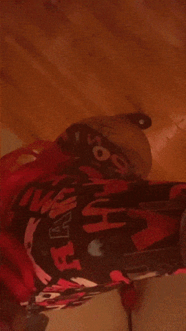 a person with red hair is wearing a hoodie that says a bathing ape
