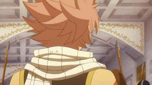 a person with a scarf around their neck is standing in a room with spears