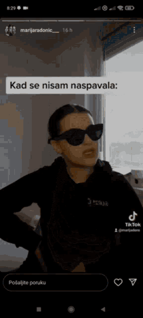 a woman wearing sunglasses and a black hoodie says kad se nisam naspavala