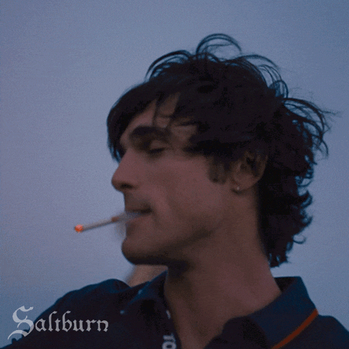 a man is smoking a cigarette and the word saltburn is on the bottom right