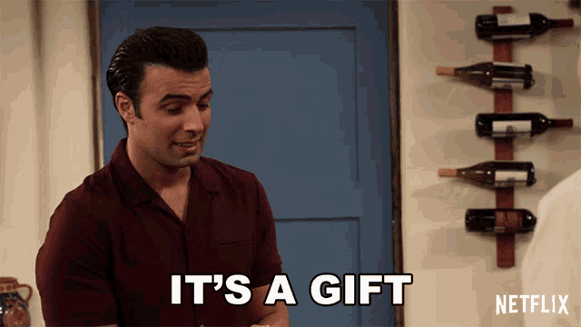 a man says it 's a gift next to a wine rack