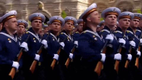 a group of soldiers marching in a parade with the word thomas on the bottom right