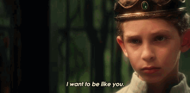 a boy with a crown on his head says i want to be like you