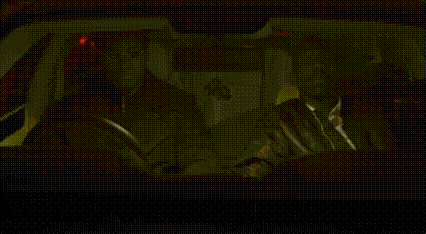 a man in a suit and tie is sitting in a car .