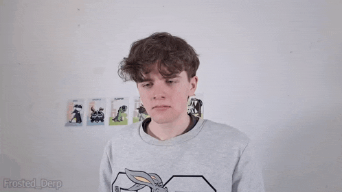a man is standing in front of a wall with pictures of animals on it