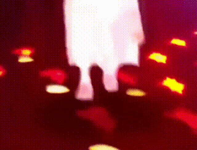 a blurred image of a person 's hands reaching out in the air
