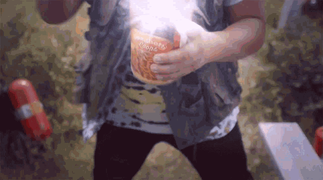 a person is holding a jar of neighborhood chowder