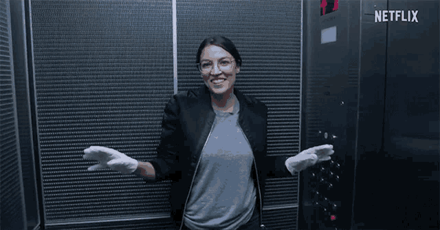 a woman is standing in an elevator with a netflix logo on the bottom