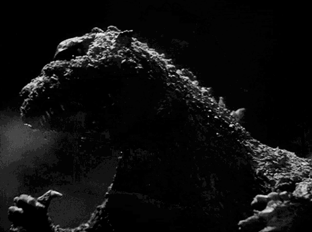 a black and white photo of a monster in front of a building that has the word baker on it