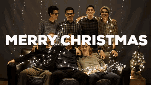 a group of young men are posing for a picture with the words merry christmas written above them