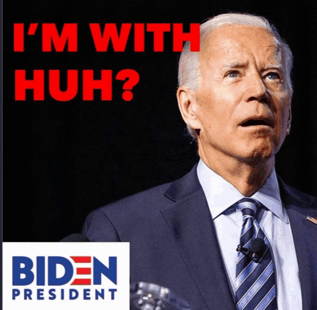 a man in a suit and tie is behind a biden president sign