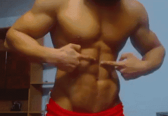 a man without a shirt is pointing at his stomach