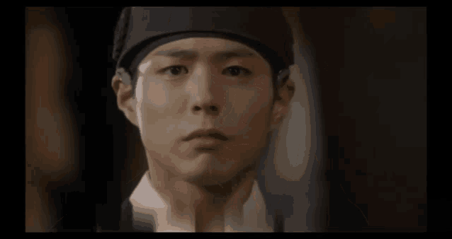 a close up of a man 's face wearing a headband