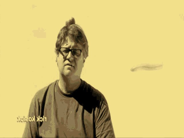 a man with glasses and an apple on his head is making a funny face .