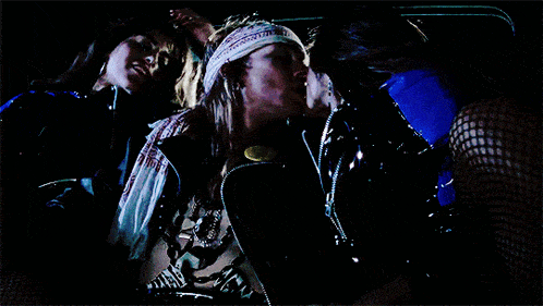 a man in a bandana is kissing another man