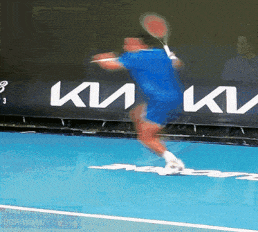 a tennis player is swinging a racket in front of a sign that says ки