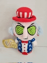 a stuffed toy of uncle sam with cucumber eyes and a hat .