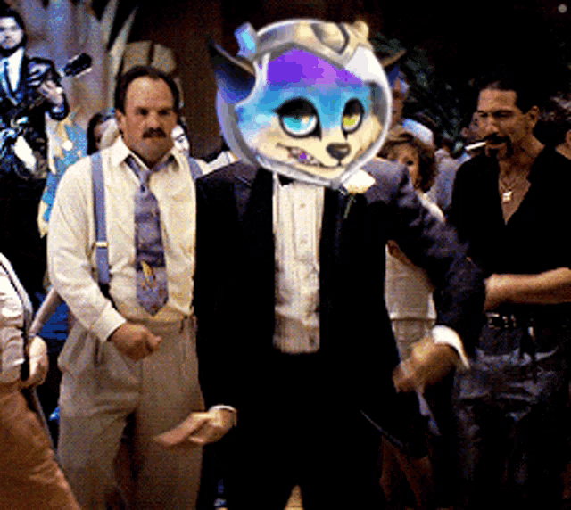 a man in a tuxedo has a cat mask on his face