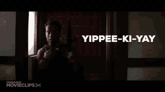 a man is holding a gun in a doorway and the word motherfucker is on the bottom of the screen .