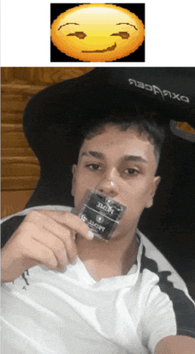 a man is holding a condom in his mouth with a smiley face behind him