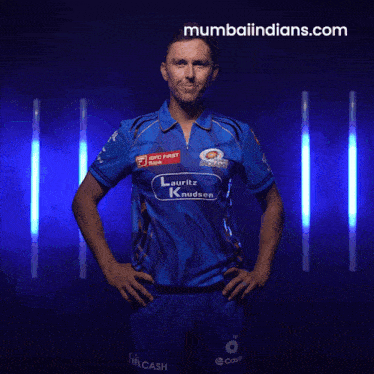 a man wearing a blue shirt that says mumbai indians on it