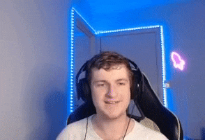 a man wearing headphones is sitting in a chair in front of a blue light .