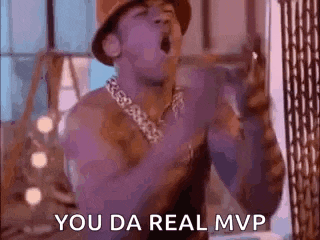 a shirtless man is singing into a microphone while wearing a hat and a chain around his neck .