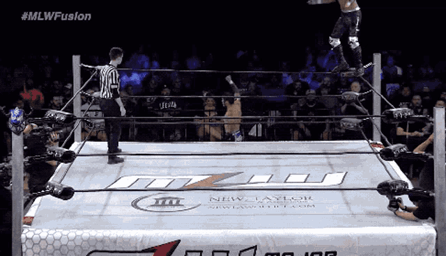 a wrestling ring with a sign that says new taylor wrestling
