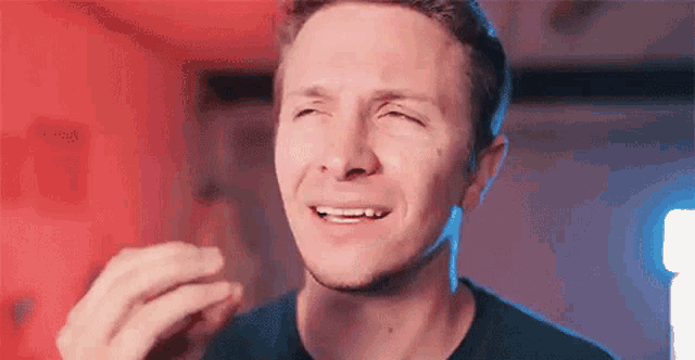 a close up of a man making a funny face .