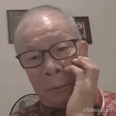 an older man wearing glasses is holding his hand to his face
