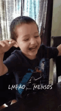 a young boy is laughing with the words lmfao mensos on the bottom right