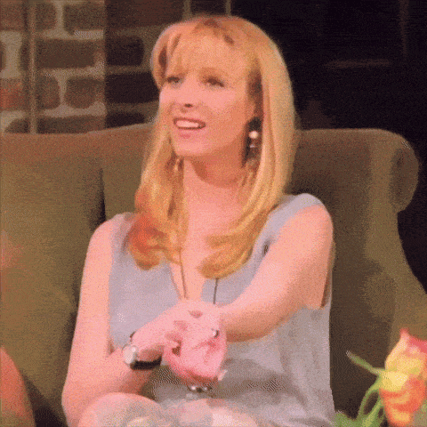 a woman with blonde hair is sitting in a chair with her arm outstretched