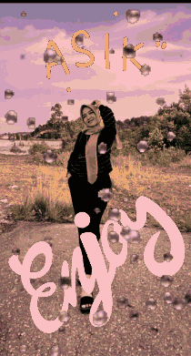 a woman in a hijab stands in front of a sign that says enjoy