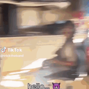 a blurred image of a person walking with a sticker that says hello on it